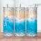 Sandy beach and water tumbler shown on all sides, featuring soft beige sand and gentle blue ocean waves wrapping the design.
